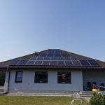 solar panels installed on the roof of a private residential house. the image shows renewable energy technology in a domestic setting.