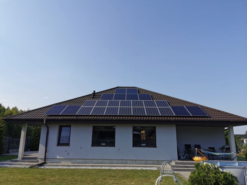 solar panels installed on the roof of a private residential house. the image shows renewable energy technology in a domestic setting.